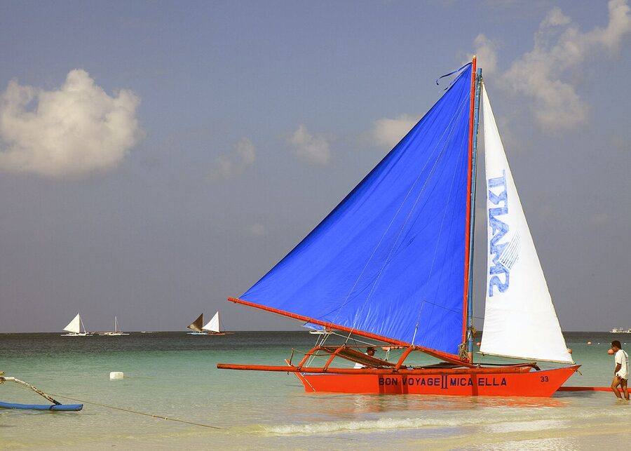 Traditional paraw outrigger sailboat on Boracay White Beach