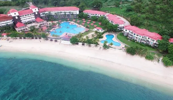 Canyon Cove pool and resort grounds at Calatagan Bay with palm trees lining the deck