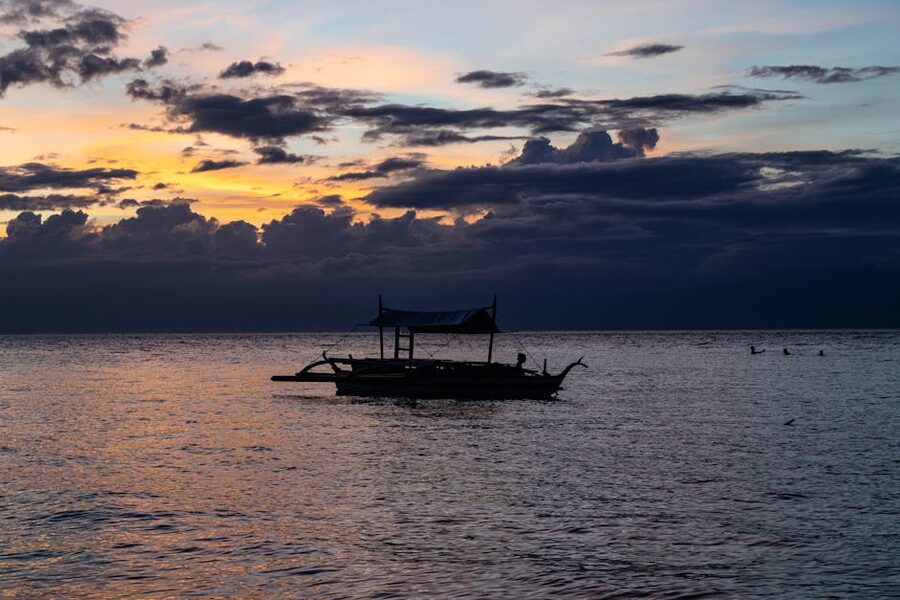 Moalboal sunset boat silhouette over the sea