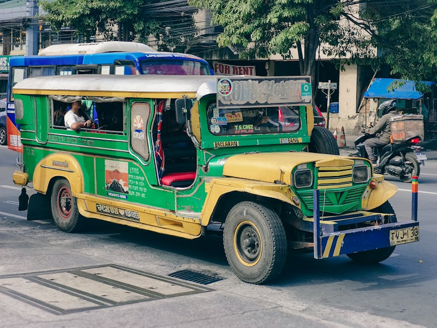 A traditional Filipino jeepney parked on a Manila street showing route signs