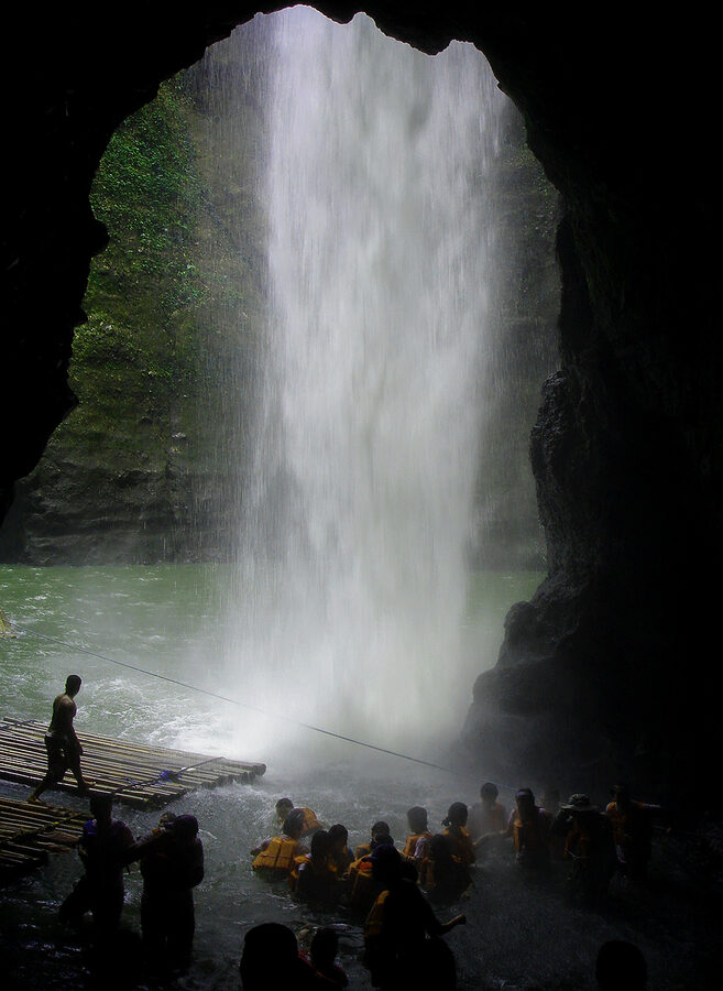 Pagsanjan Falls in Laguna with bancas carrying tourists in life jackets through the gorge