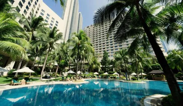 EDSA Shangri-La Manila garden pool surrounded by palm trees with the hotel tower behind