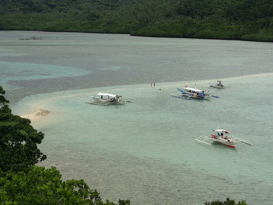 Snake Island sandbar at low tide, El Nido, with a curved white sand spit between turquoise water