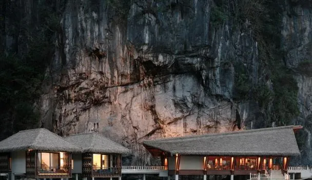 Lagen Island Resort cottages with limestone backdrop El Nido