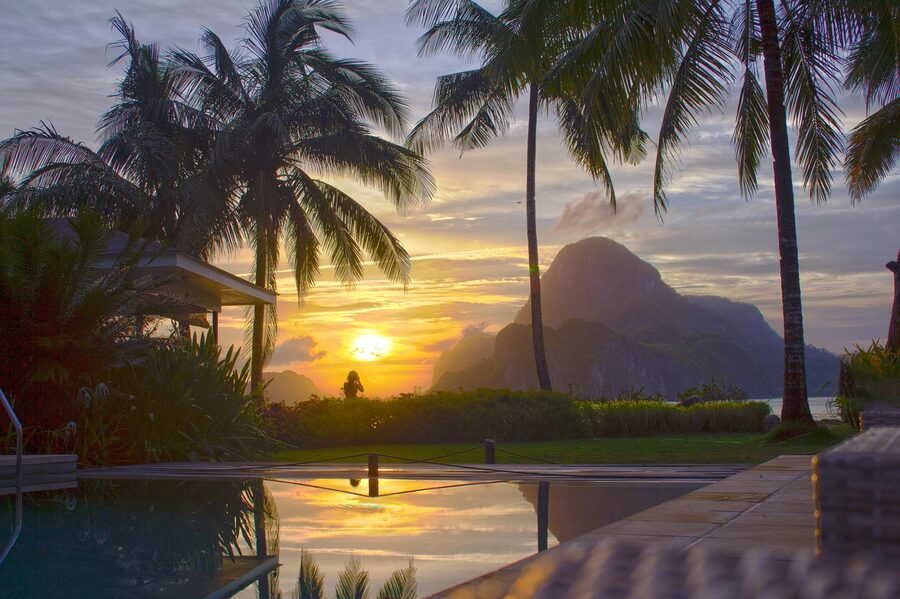 Sunset over Cadlao Island from a Corong-Corong resort pool