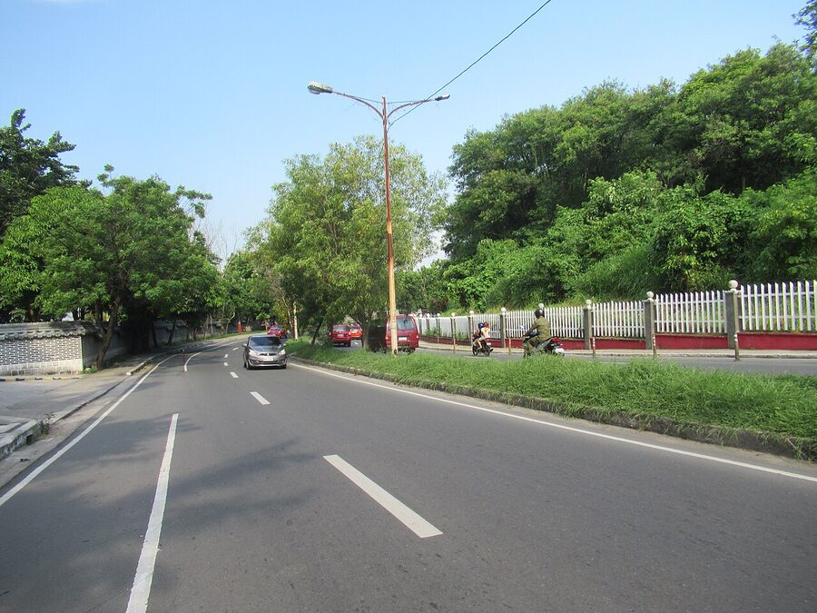 Wide pedestrian street in Bonifacio Global City with skyscrapers in background