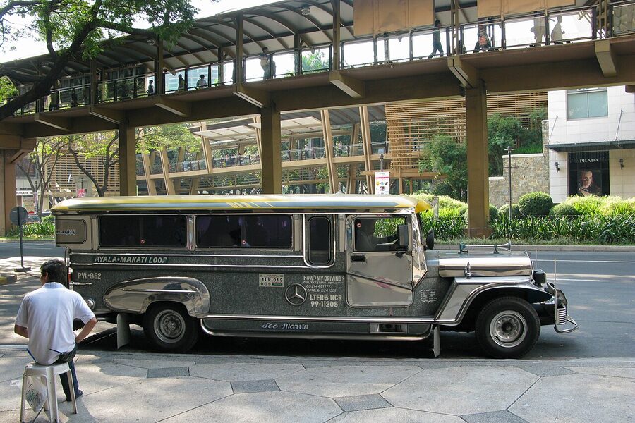 Painted Manila jeepney from the side on a Philippine road