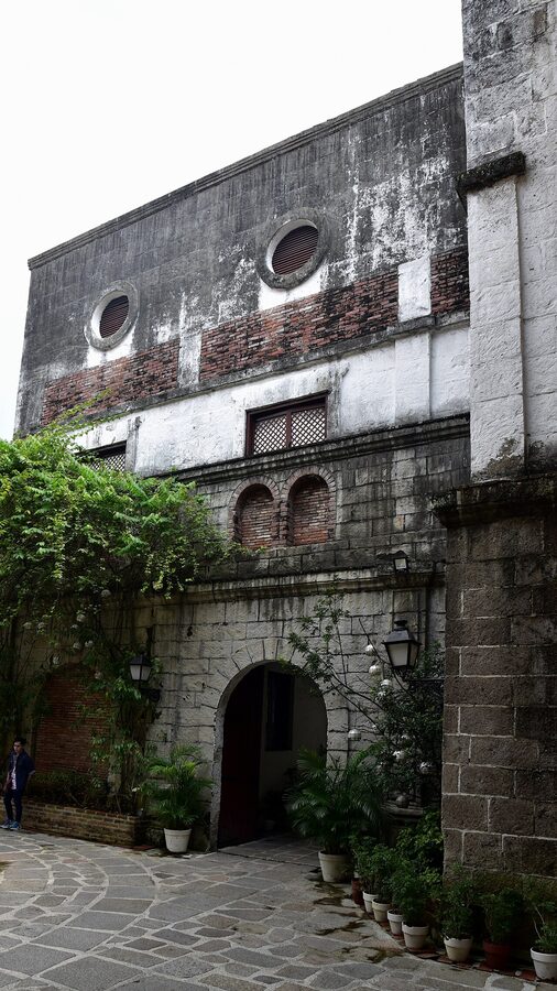 The restored facade of a heritage building in Plaza San Luis Complex, Intramuros, with capiz-shell windows