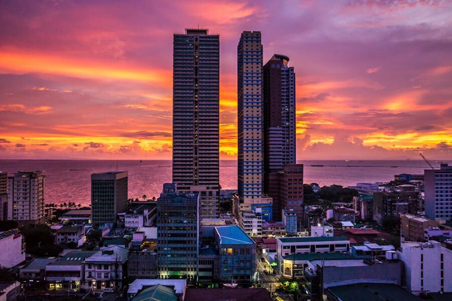 Manila skyscrapers during a colourful sunset over Manila Bay