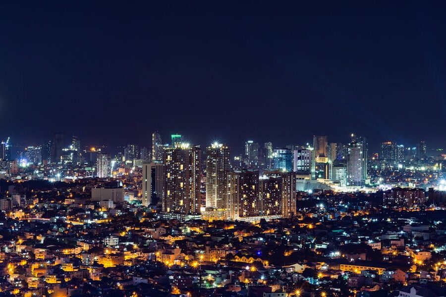 Illuminated Manila skyline at night reflecting on the water
