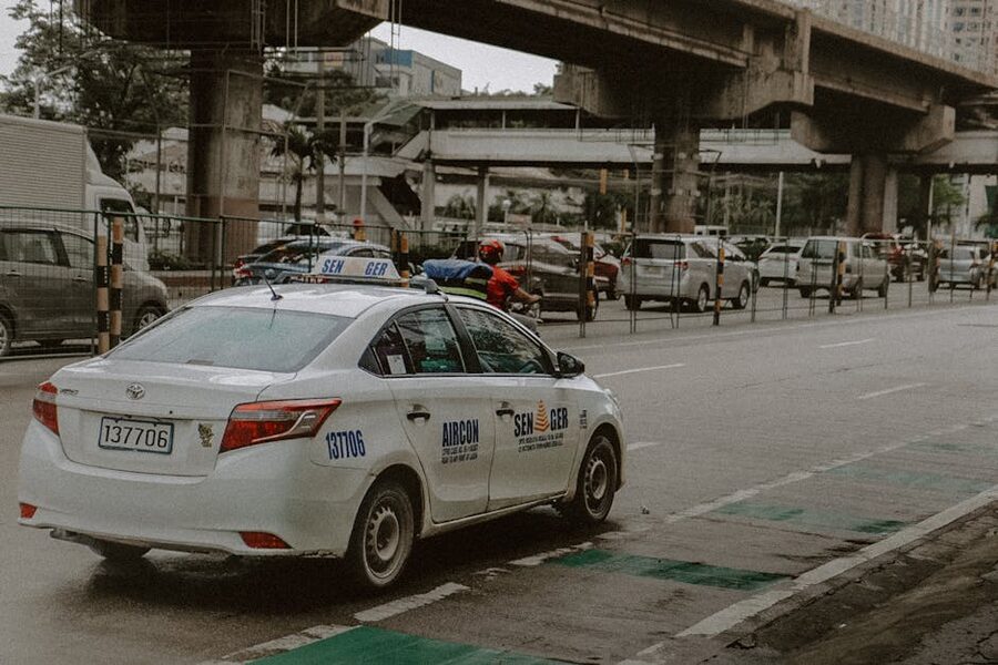 White taxi on a busy Quezon City street