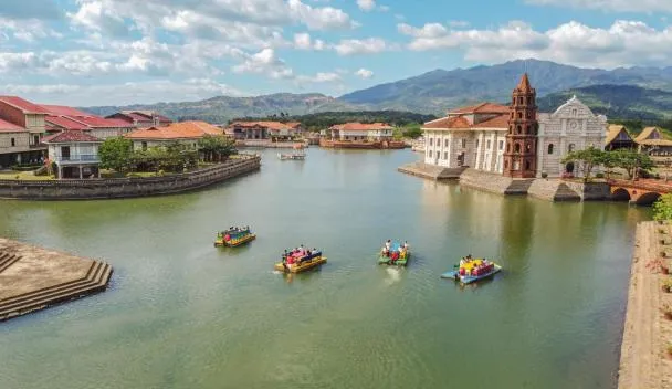 Las Casas Filipinas heritage village along the canal with colourful boats and Spanish-era houses