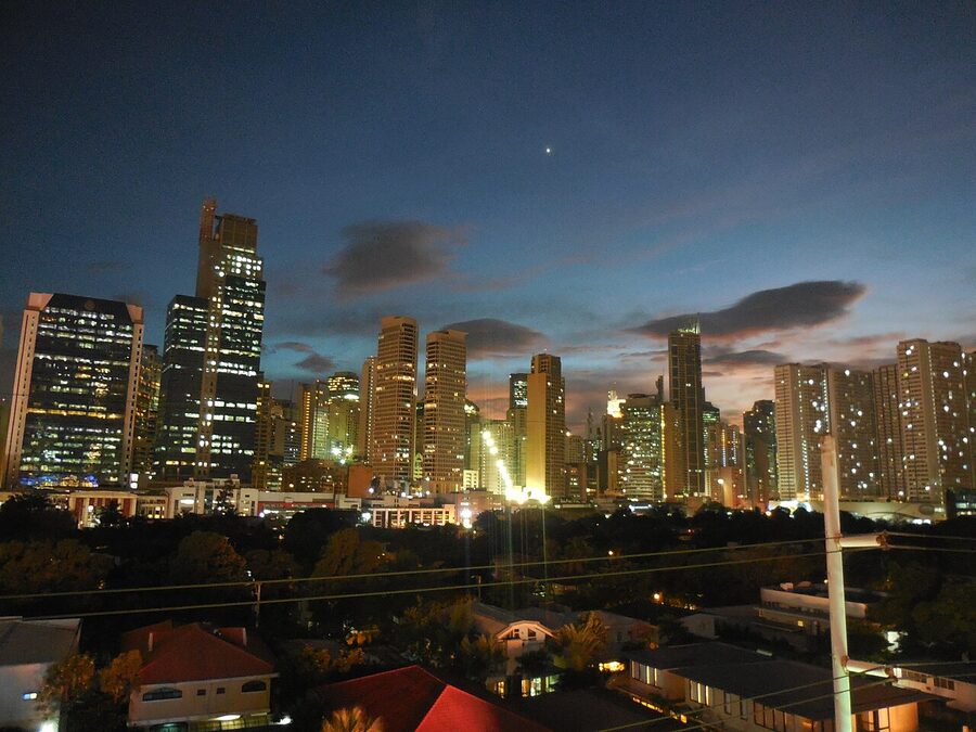 Makati CBD skyline lit up at night with high-rise buildings