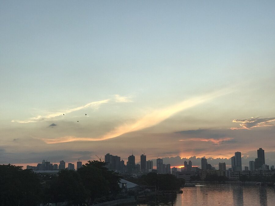 Manila skyline at sunset from Pandacan Bridge with red and orange clouds over the city