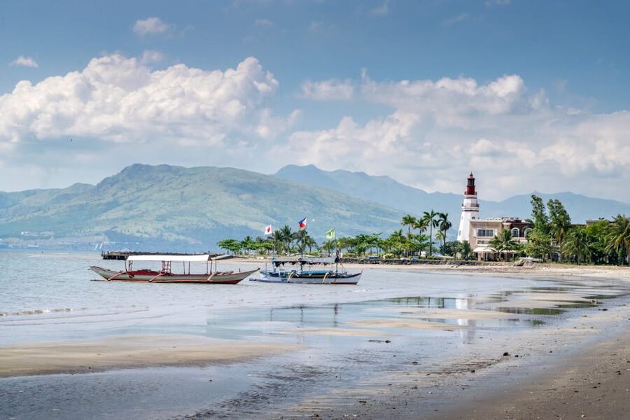 Subic Bay Philippines lighthouse and outriggers with mountains beyond