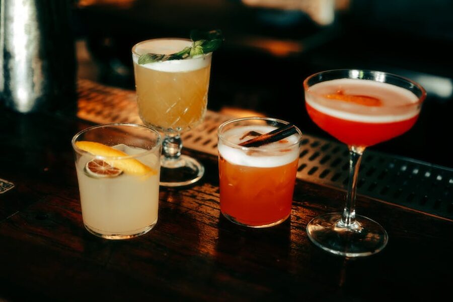 Selection of cocktails arranged on a backlit bar counter