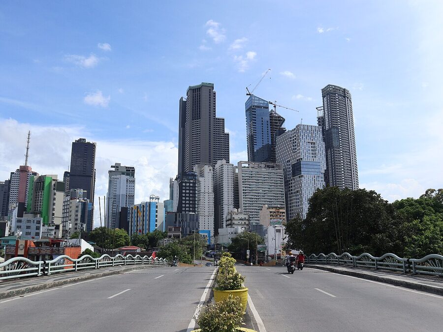 Makati skyline towers behind the low-rise houses of Poblacion