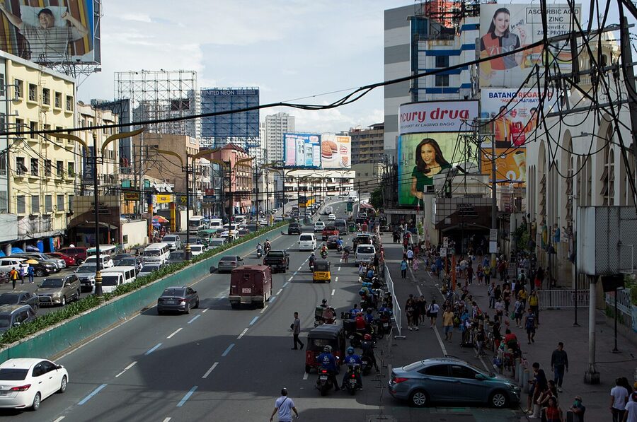 Quezon Boulevard southbound at Quiapo Manila with billboards traffic and pedestrian crossings