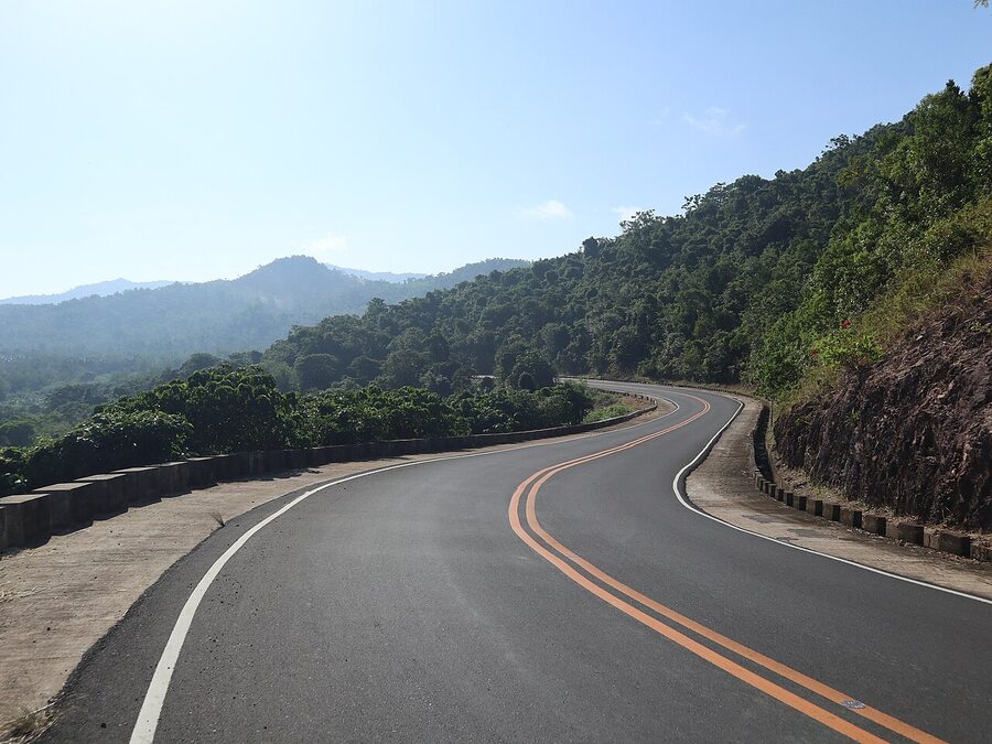The Taytay-El Nido Highway curving through forested mountains in northern Palawan