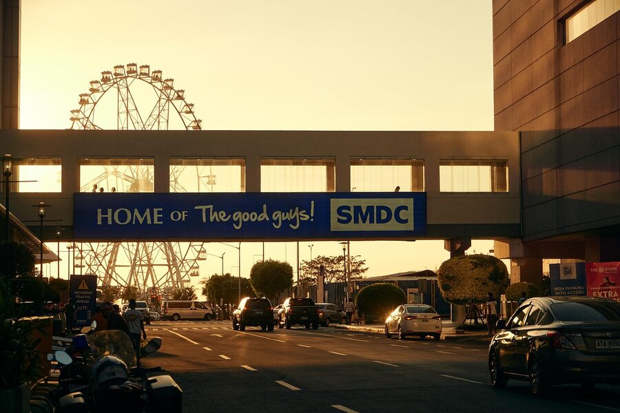 MOA Eye ferris wheel above the Mall of Asia entrance road at golden hour Pasay