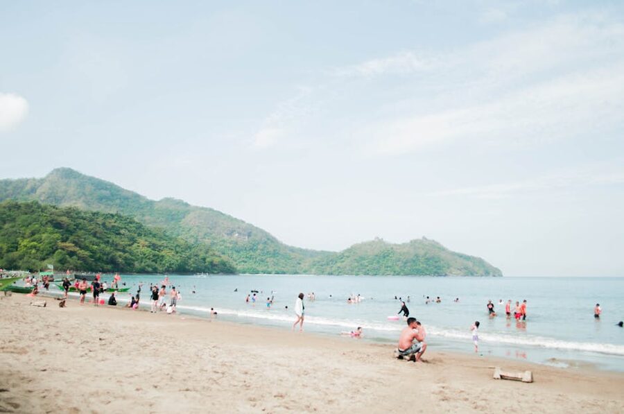 Families on a Nasugbu beach in Batangas with mountains in the background