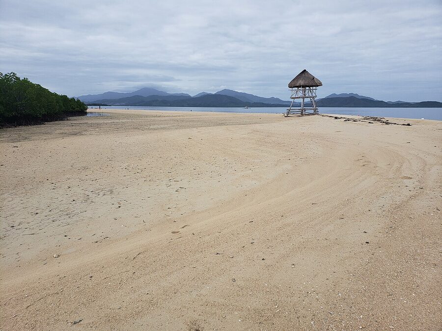 Sandy beach with a thatched watchtower on a Honda Bay island near Puerto Princesa, Palawan