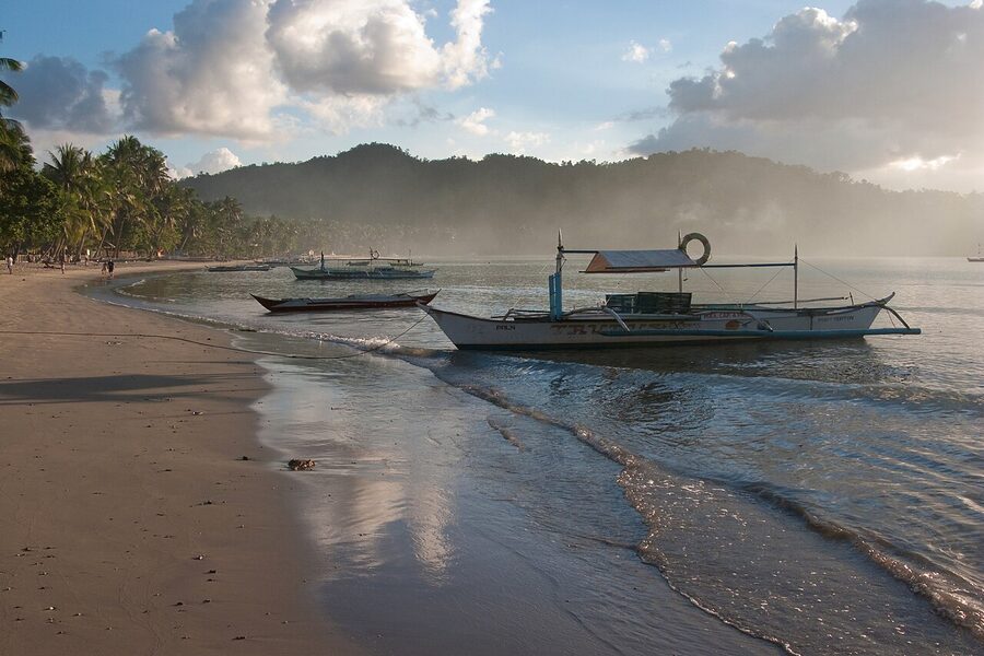 Bangka boats moored at sunset on Port Barton beach, Palawan
