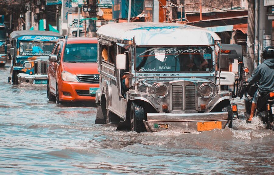 Jeepney navigating flooded street in Metro Manila during typhoon