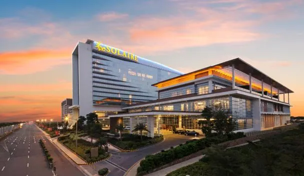 Solaire Resort Manila exterior with the curved hotel facade and reflecting pool