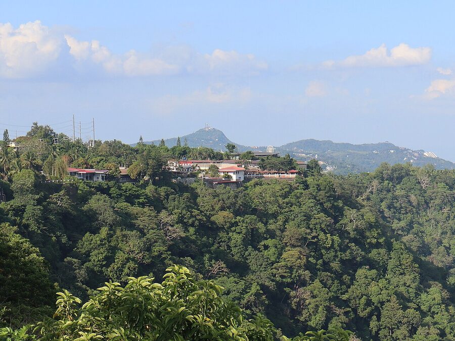Tagaytay Ridge with Mount Sungay rising in the distance under a cloudy sky