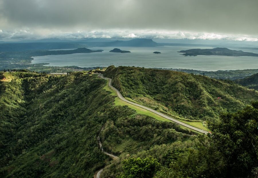 Aerial view of the winding road climbing the Tagaytay ridge with mountain backdrop