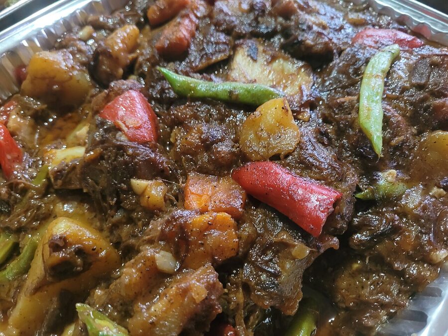 Kare-kare beef stew in peanut sauce with vegetables and bagoong shrimp paste