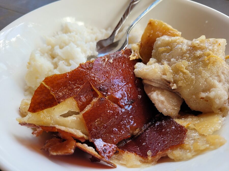 Crispy Filipino lechon with white rice in a bowl