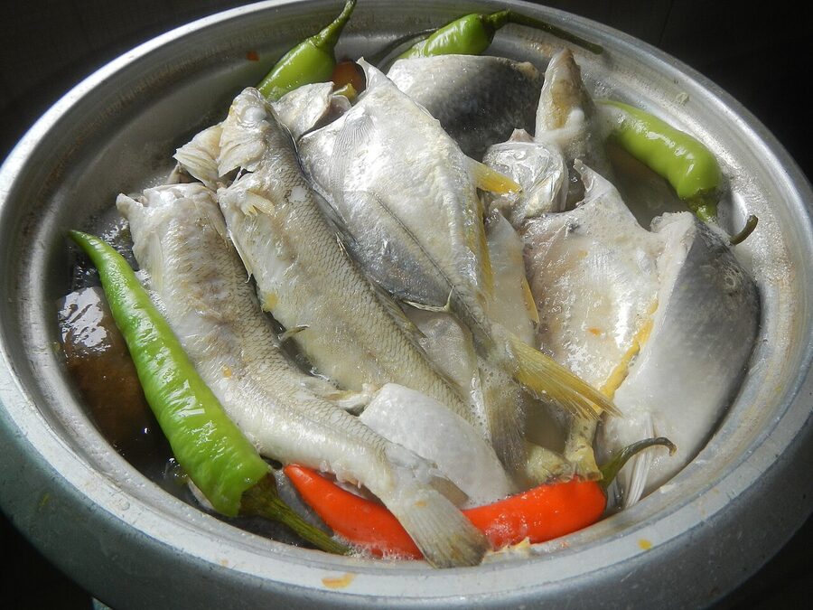 Sinigang na isda fish soup with green chillies served at a Filipino home kitchen