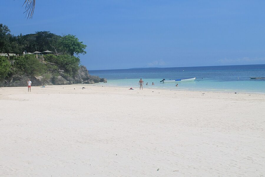 Alona Beach Panglao with white sand and small outrigger boats