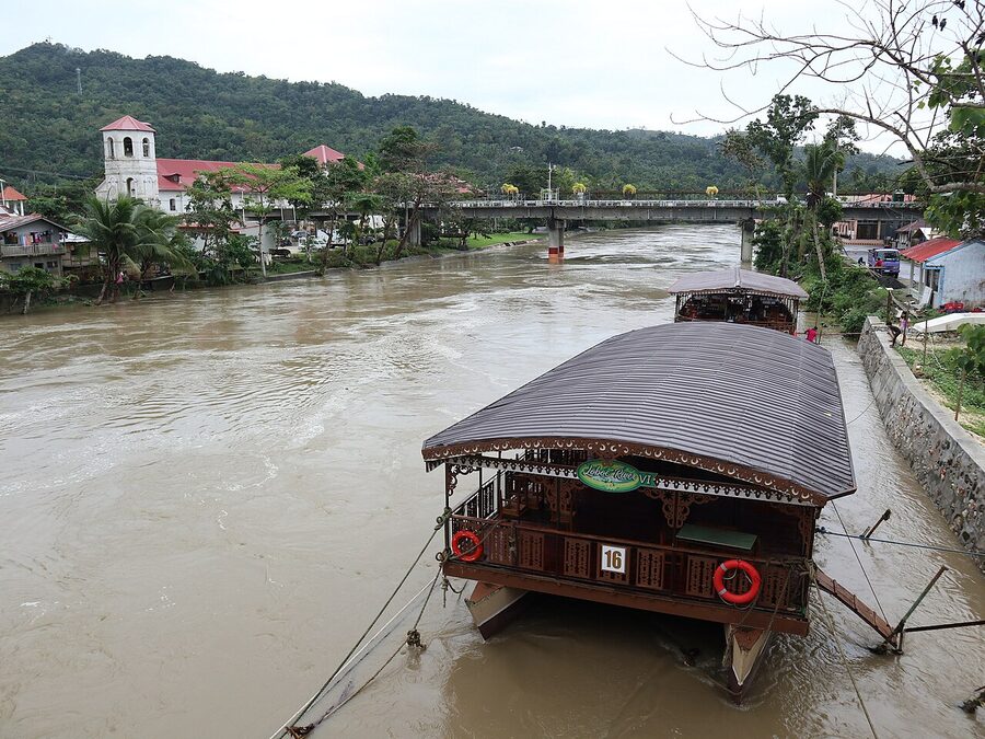 Loboc River cruise boat with bridge and church in background Bohol